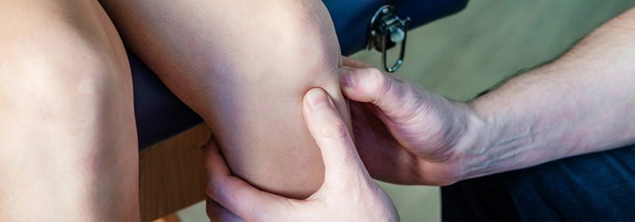 Trigger point therapy being performed on a patients knee.