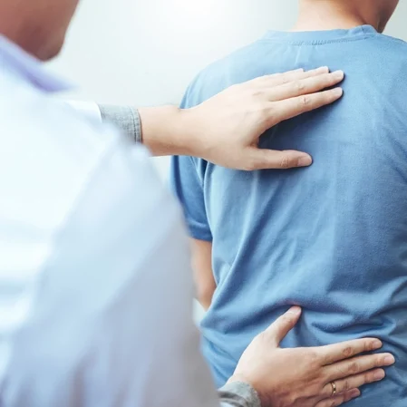 A doctor performing a back exam.