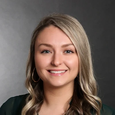 Aimee Day smiling, she has blonde hair.