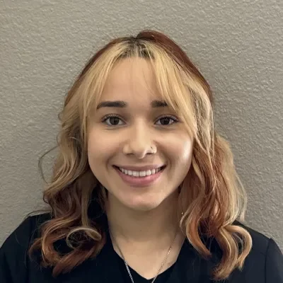 Isabel Aiyeo Jenku smiling in a black shirt.